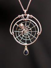 Load image into Gallery viewer, Silver pendant with spider and web design on a dark background